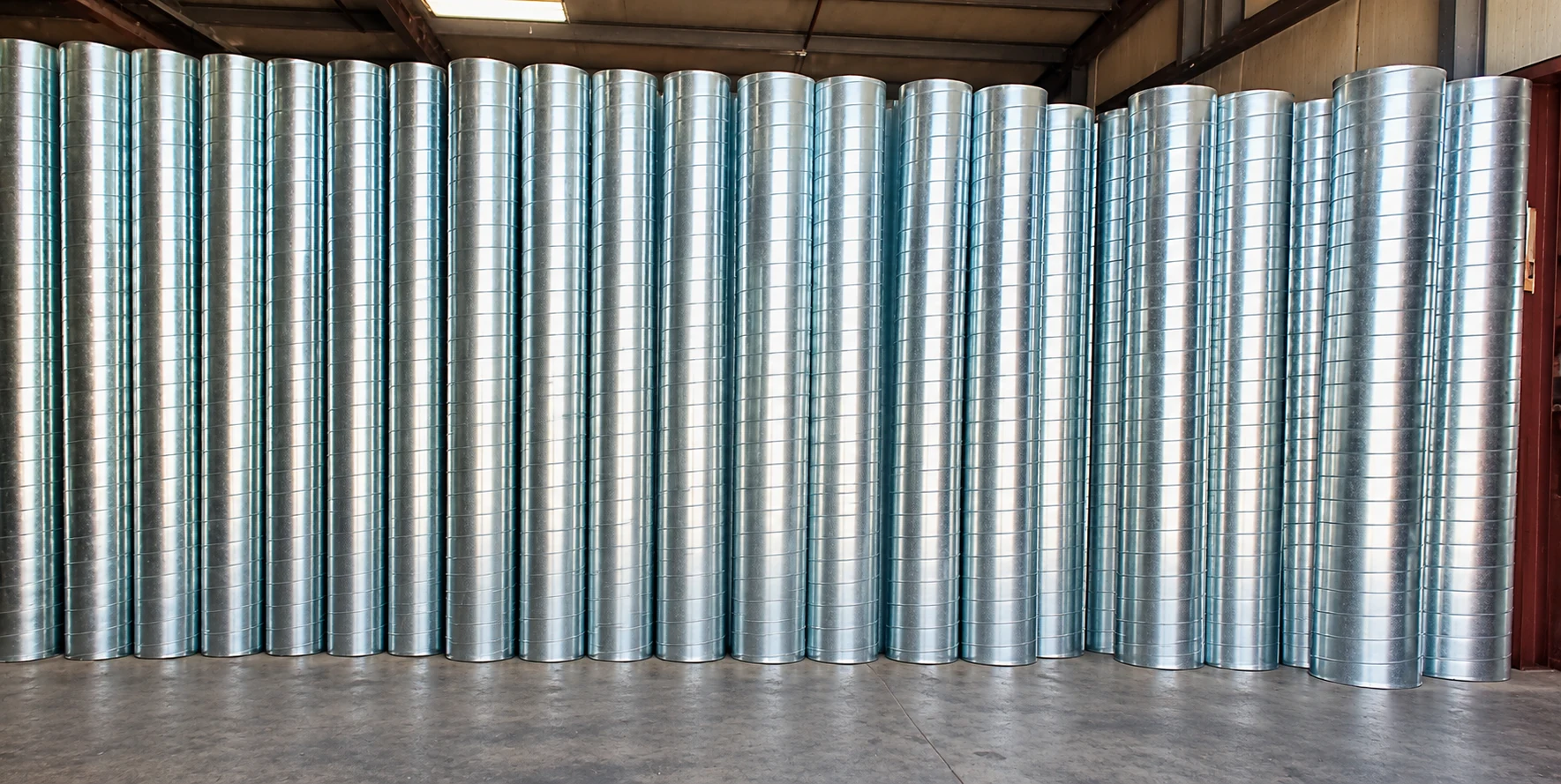 Rows of galvanized spiral duct fabricated by Custom Duct Manufacturing